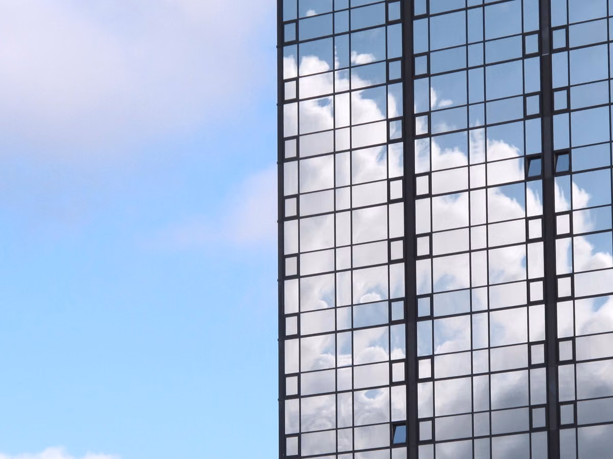 A striking view of a skyscraper in Gothenburg, Sweden, with clouds reflecting on its glass facade.